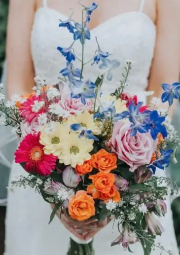 Hand-Tied Wedding Bouquet loose round just picked styling with delphiniums. Katie Dervin Photography